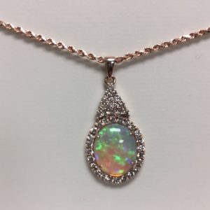 A Special Customer came to us with a Very Special Request...Reset Her Mother's Treasured Opal into a Sentimental "Something Borrowed" for Her Niece. 

 The Finished Piece...a Gorgeous Opal wrapped in a Diamond Halo set in 14 Karat Rose Gold really showing off that Incredible Fiery Opal!